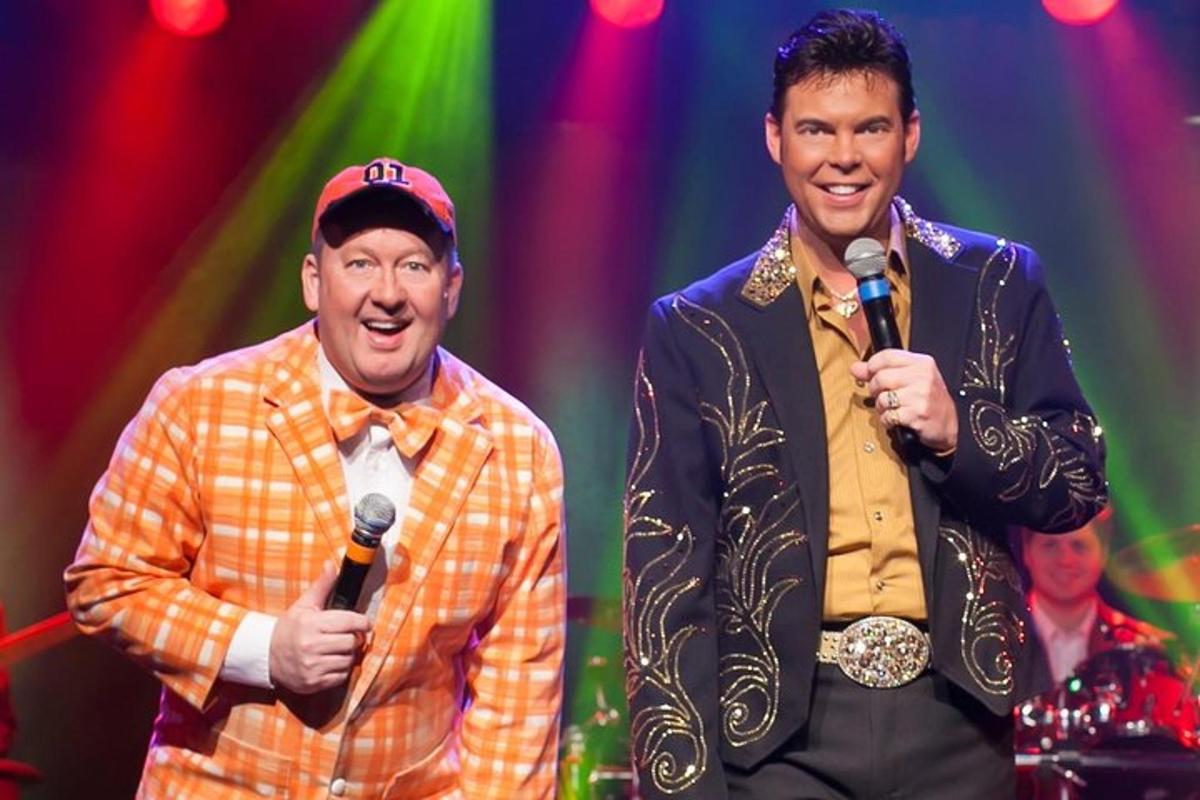 two men standing on a stage with microphones