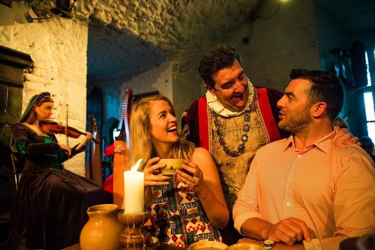 a group of people standing around a table with a candle