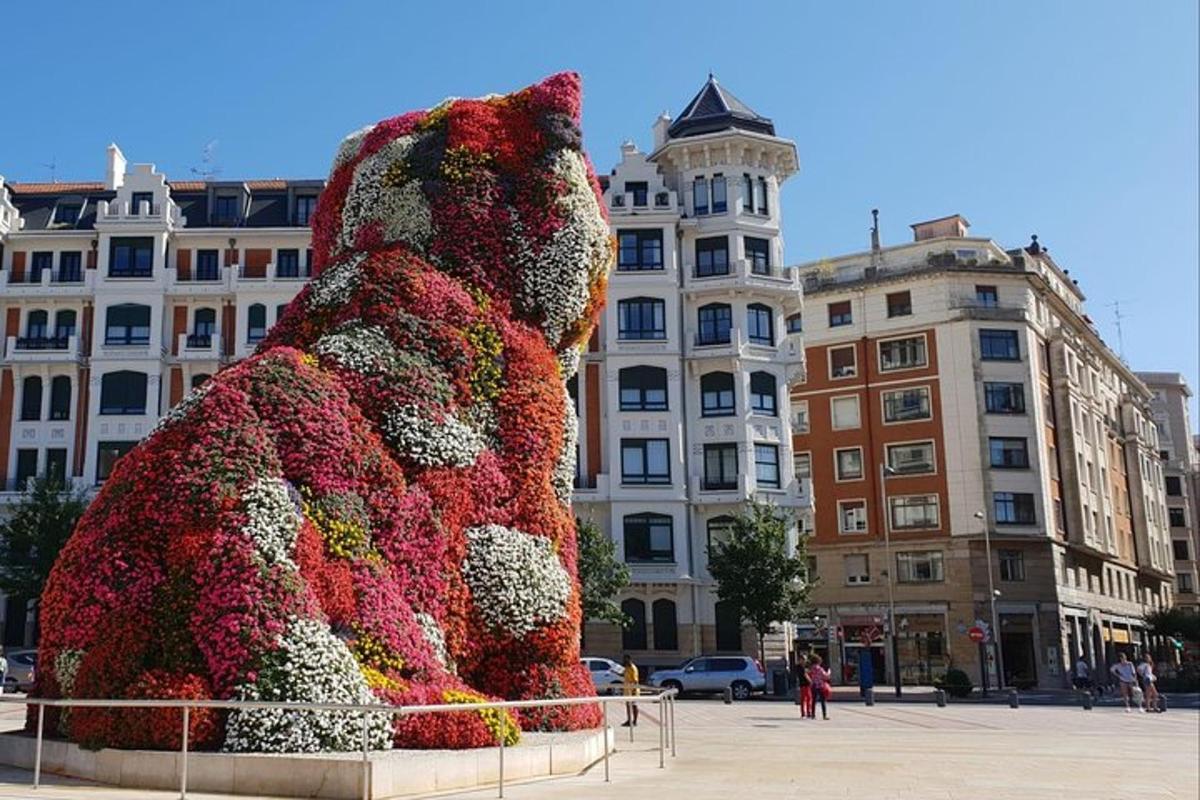 a large sculpture of a teddy bear surrounded by flowers
