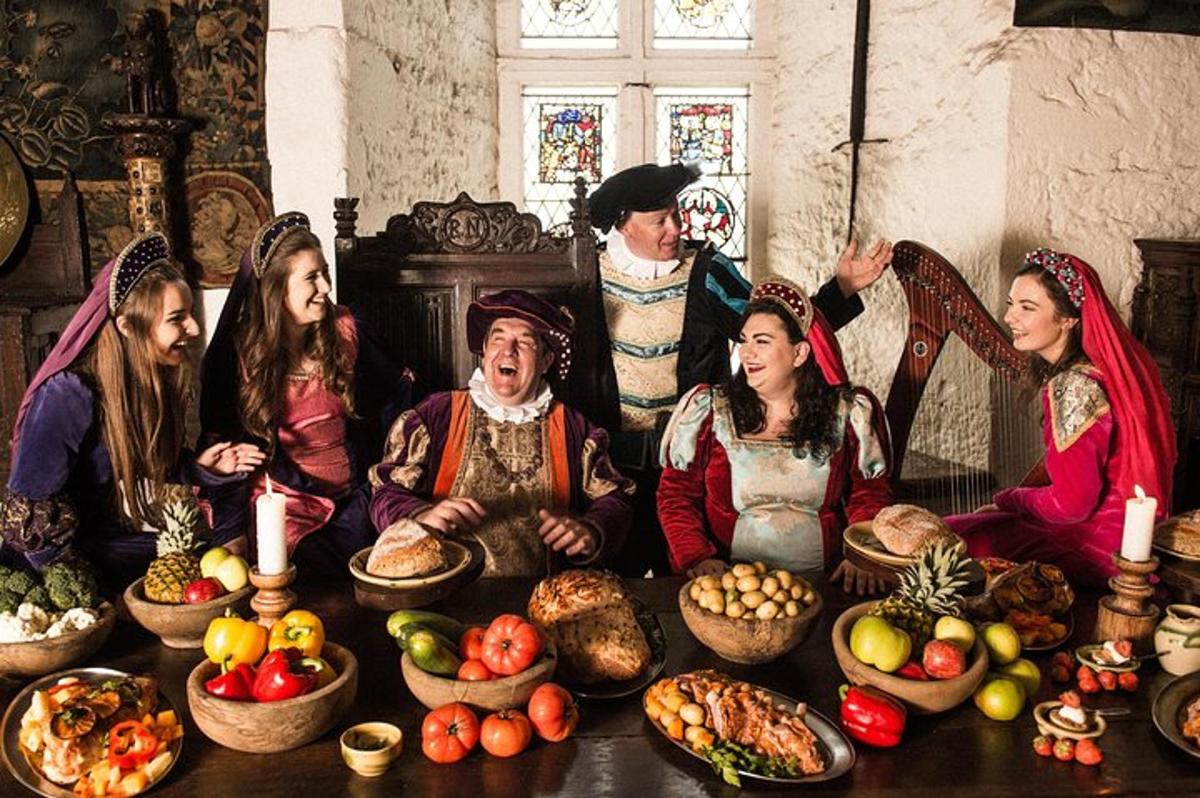 a group of people sitting around a table with food