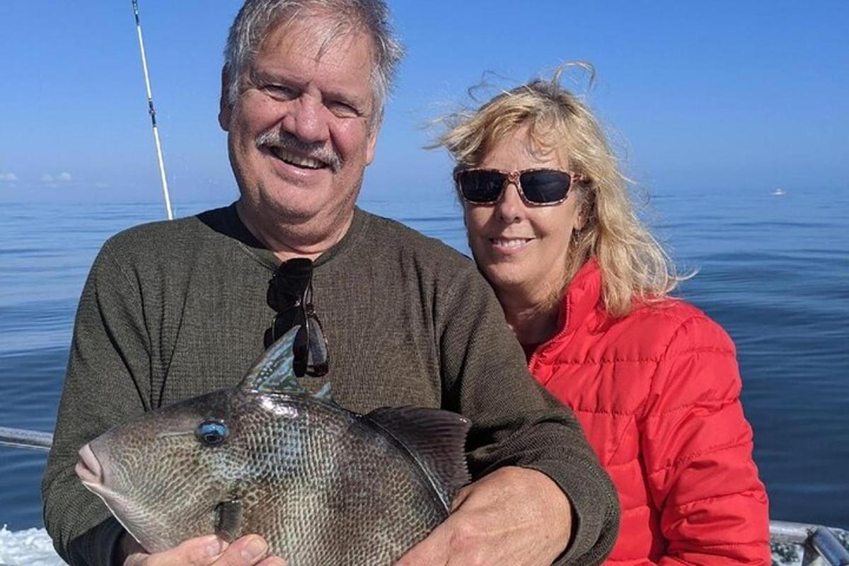 a man and woman on a boat with a fish