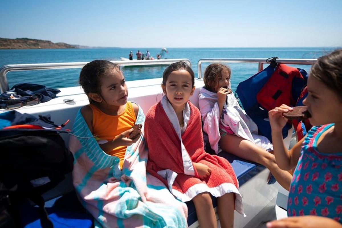 a group of children sitting on a boat