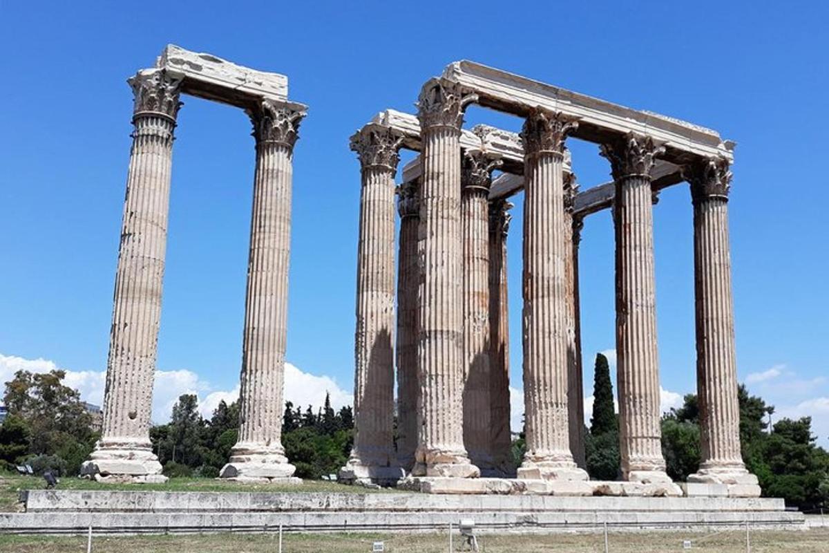 an ancient temple with columns in front of a blue sky