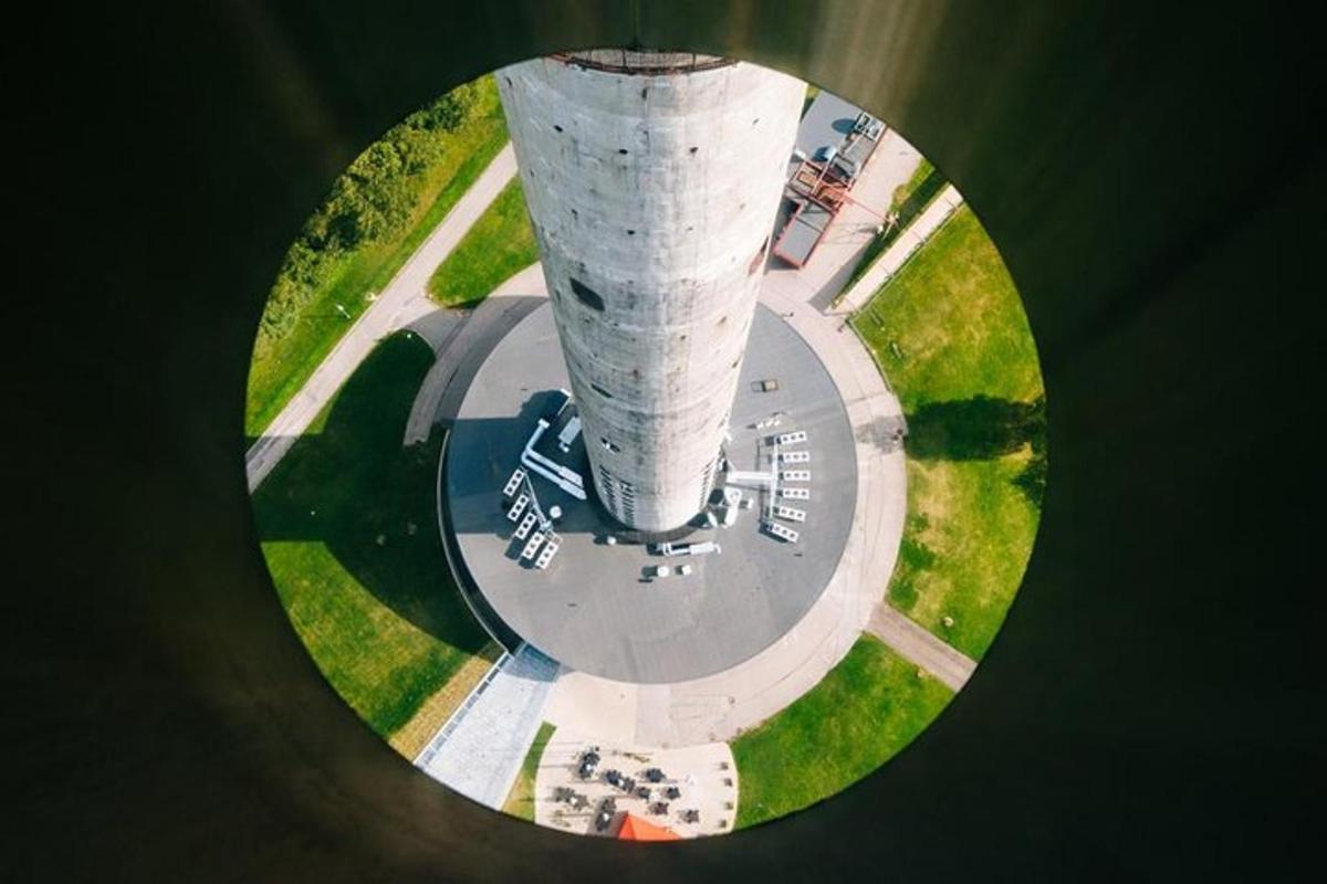 an overhead view of a concrete tower with parked cars