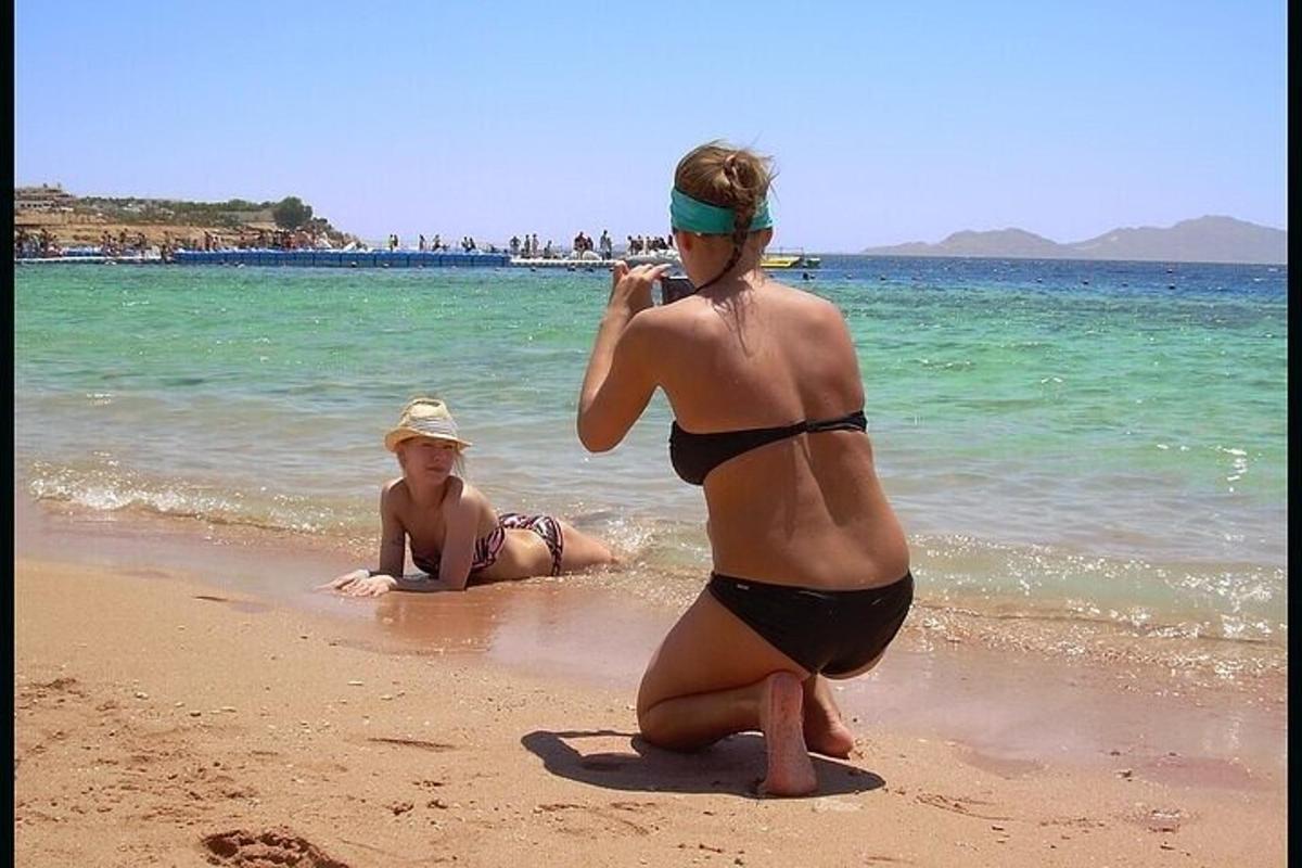 two women in bathing suits on the beach