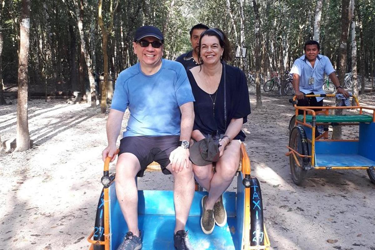 a man and a woman riding on a horse drawn cart