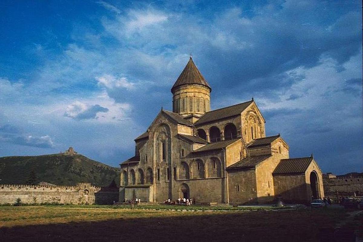 an old church with a tower on a field