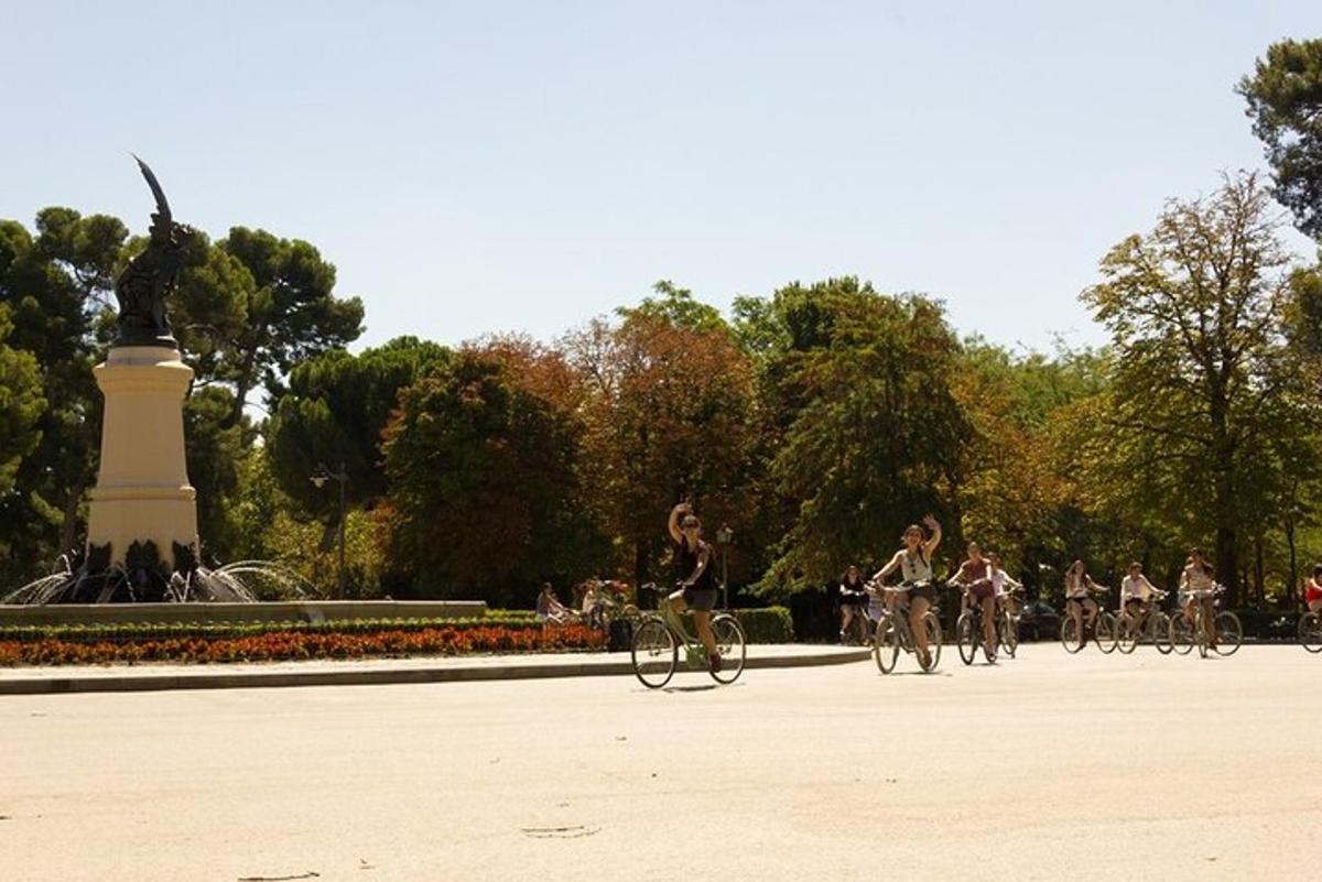 a group of people riding bikes in a park