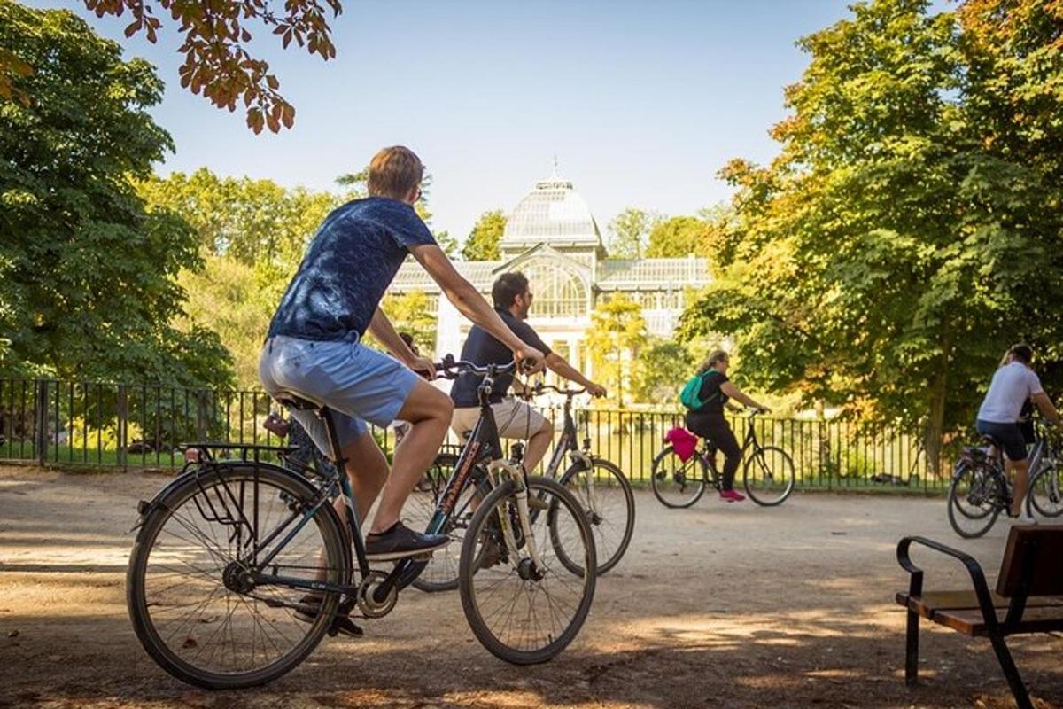 a group of people riding bikes in a park