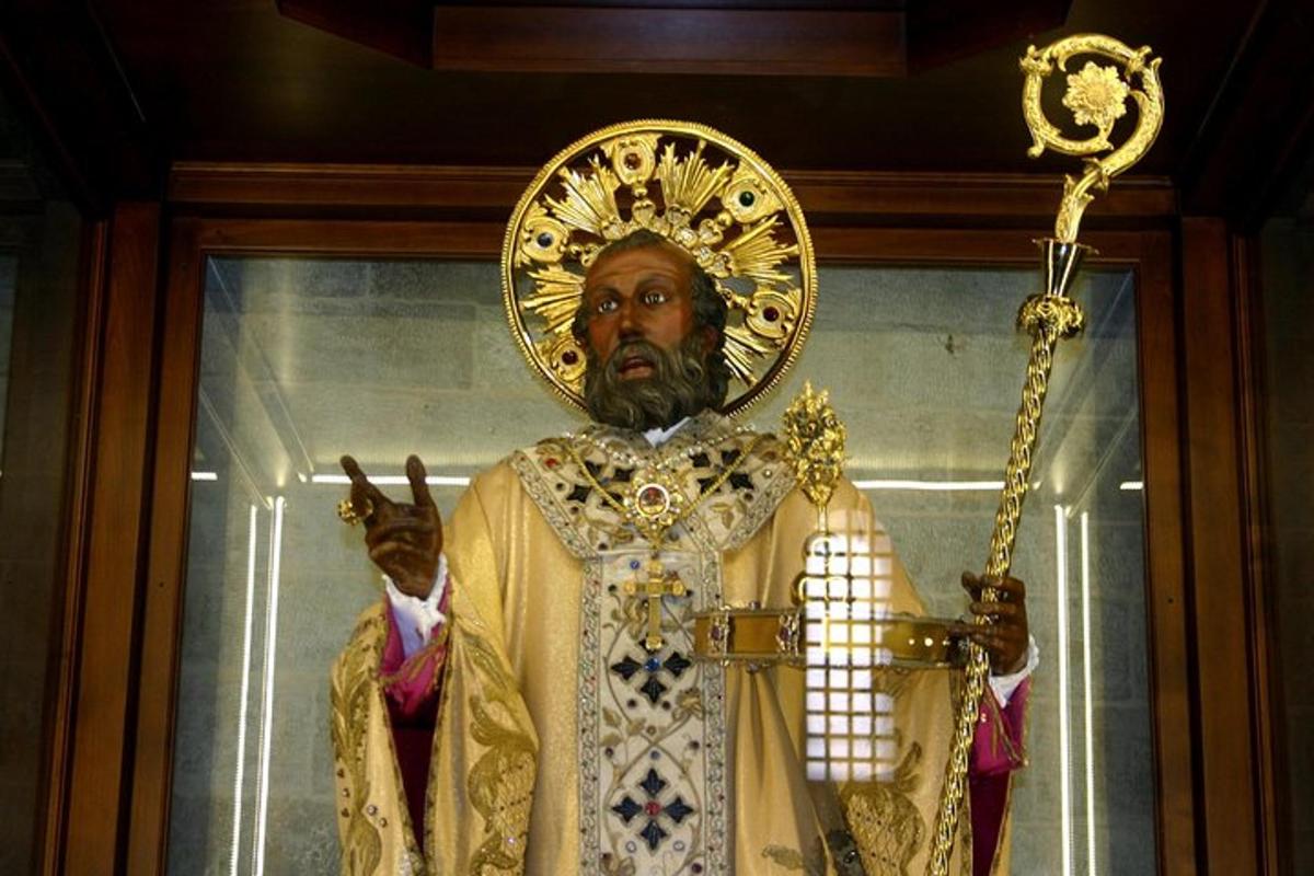 a statue of a man holding a cross