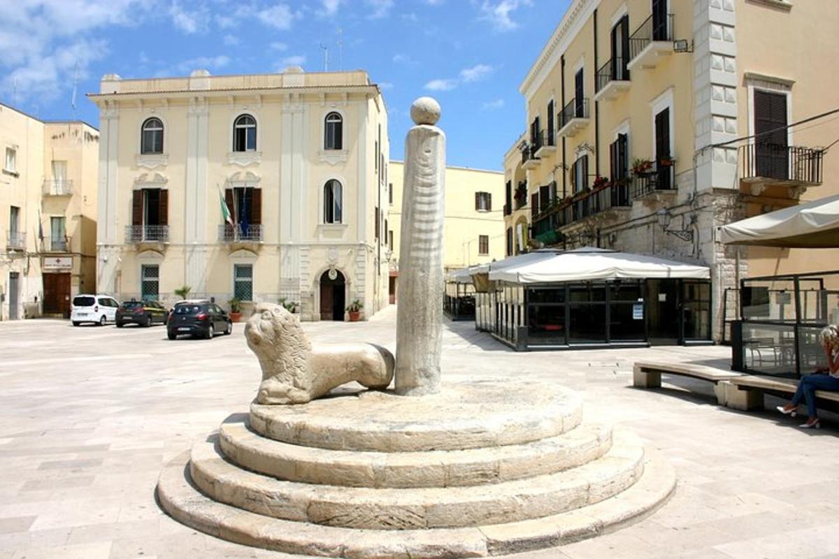 a statue of a lion on a pole in a courtyard
