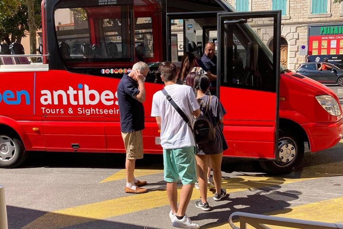 skupina lidí nastupujících do červeného autobusu