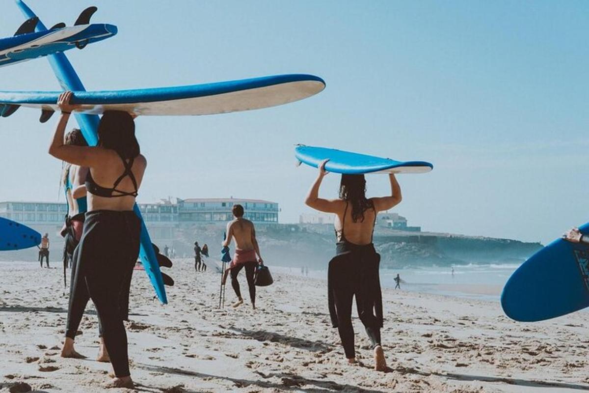a group of people on the beach with surfboards on their heads