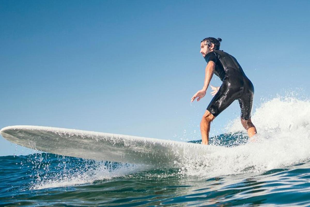 a man riding a wave on a surfboard in the ocean