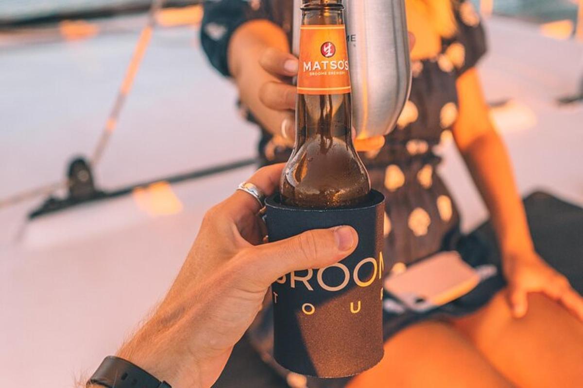 a person holding a beer bottle in their hand