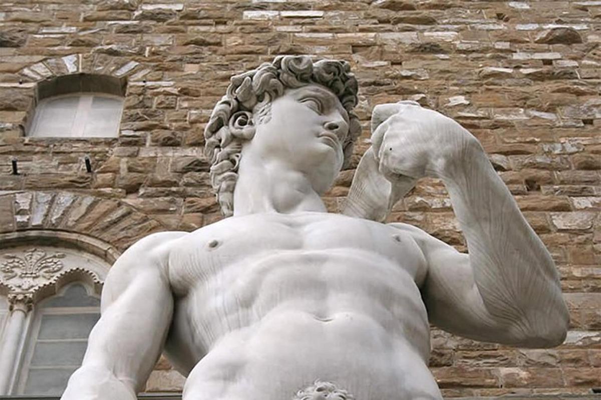 a statue of a man standing in front of a building