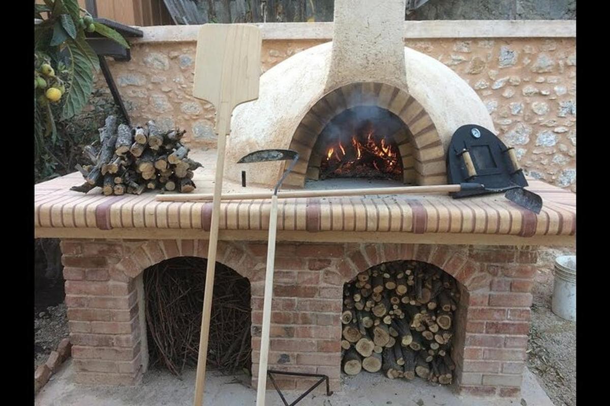 a brick oven with a bunch of logs in it