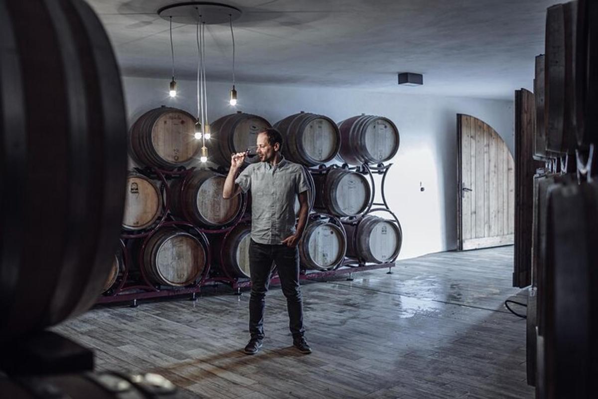 a man standing in front of a bunch of barrels