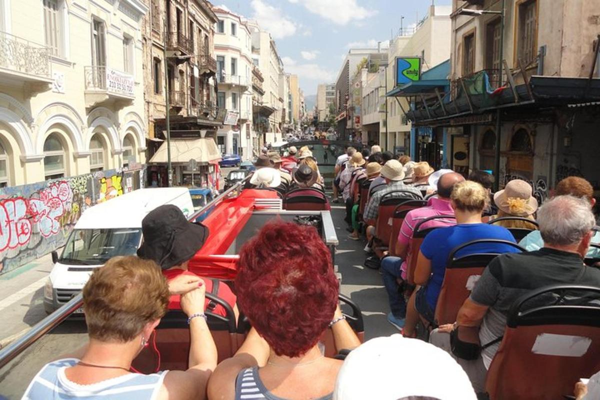 a group of people riding on a bus down a street