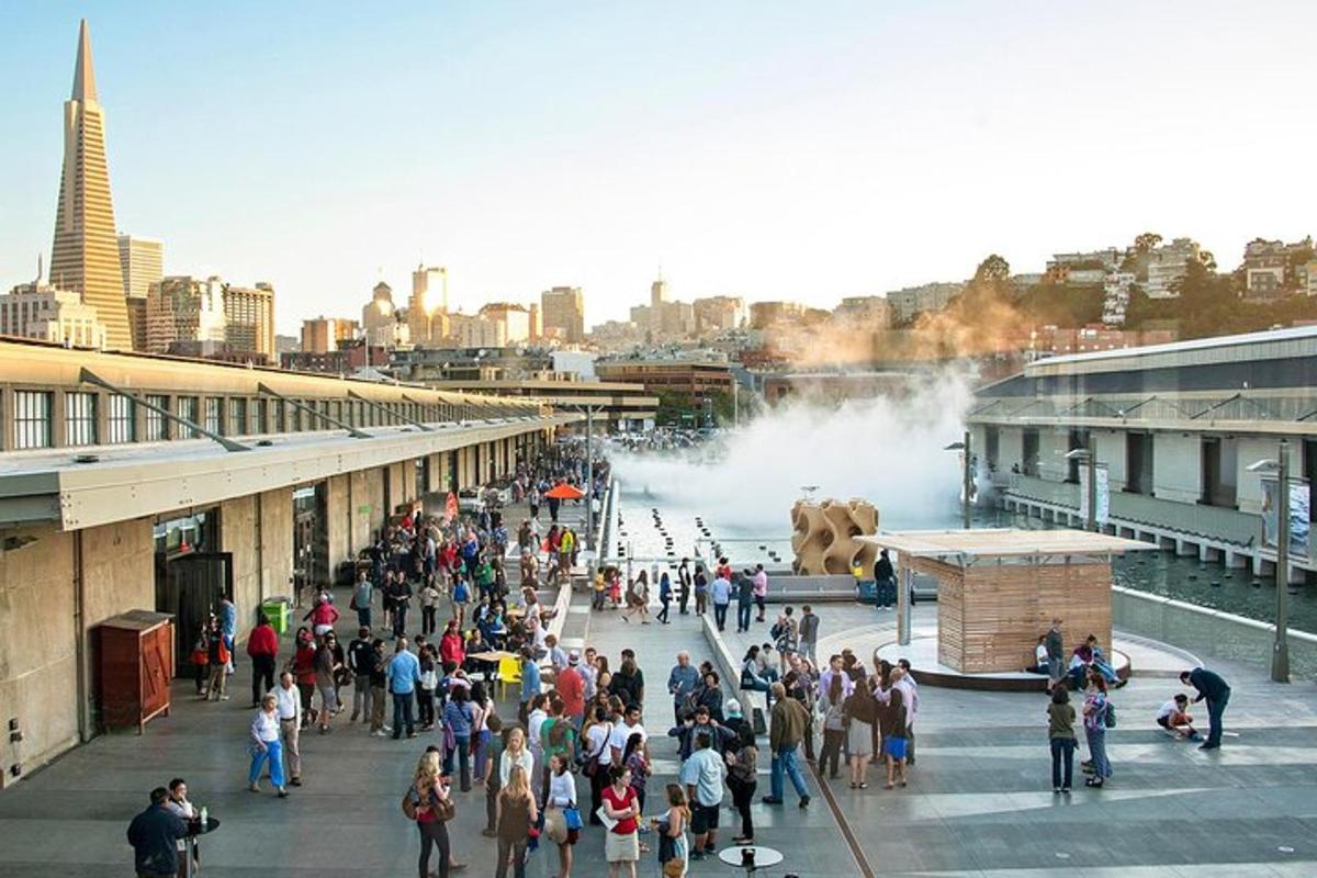 a crowd of people standing in front of a water fountain