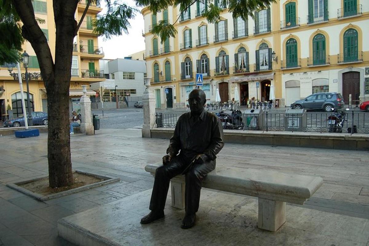 a man sitting on a bench in front of a building