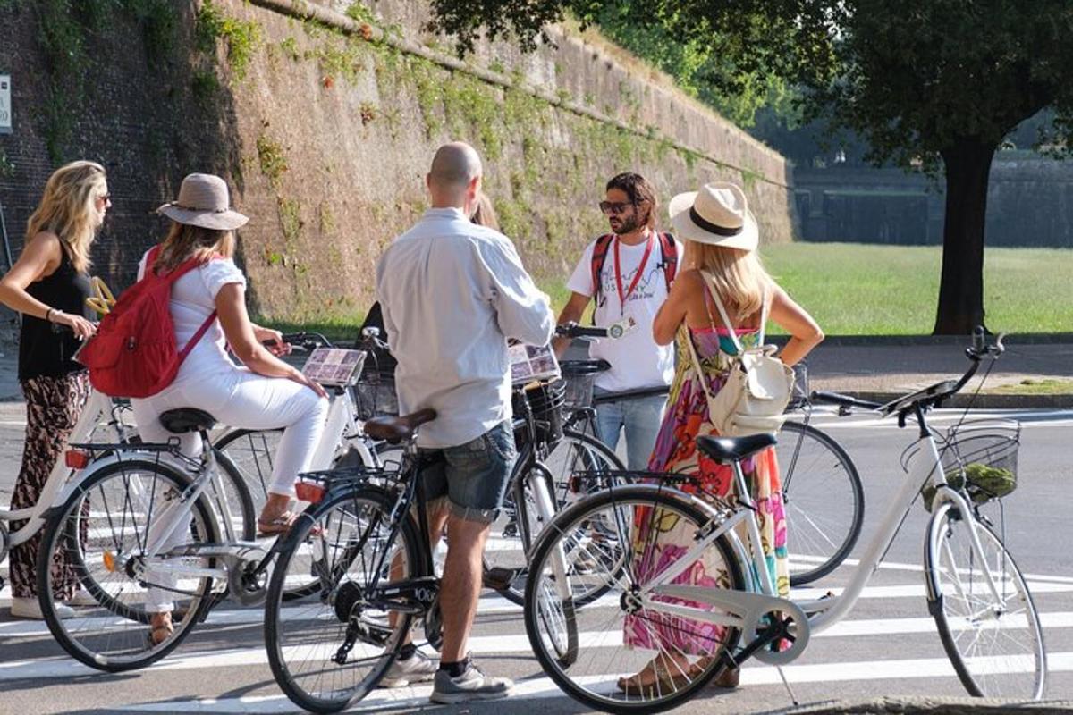 en gruppe mennesker, der står med cykler på en gade