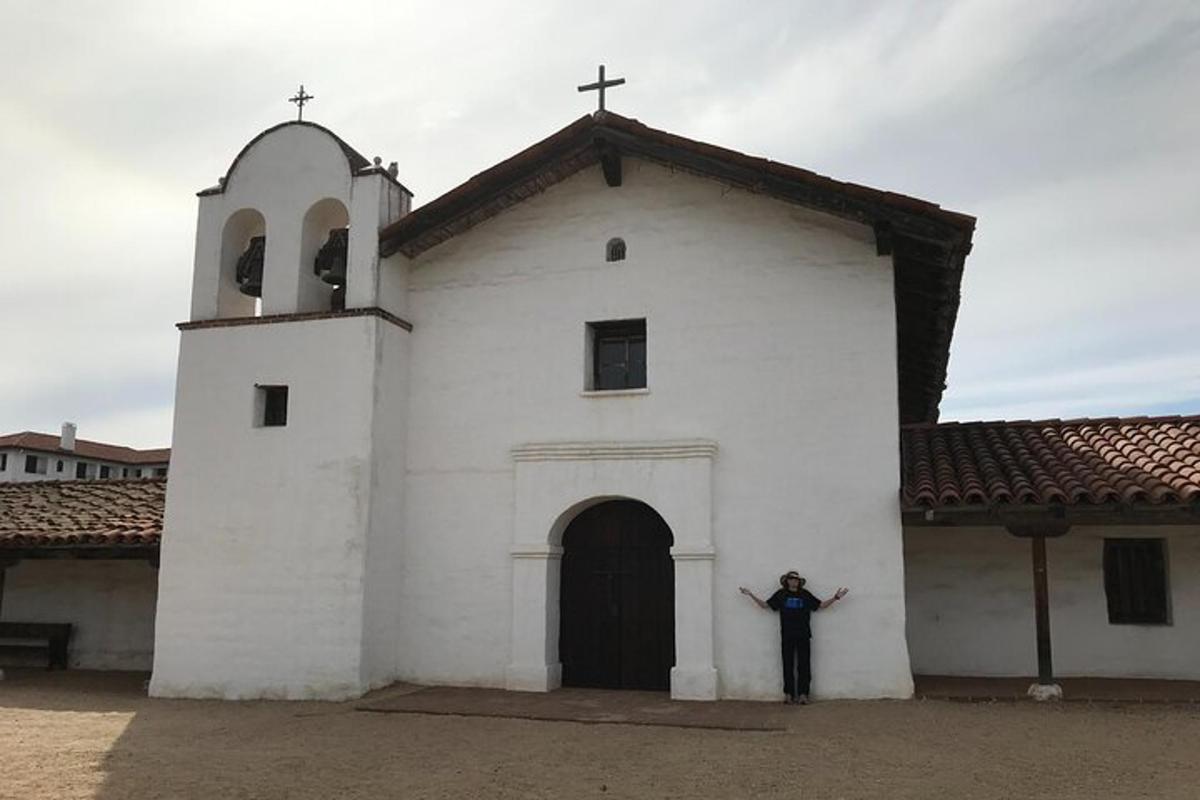 a person standing in front of a white church