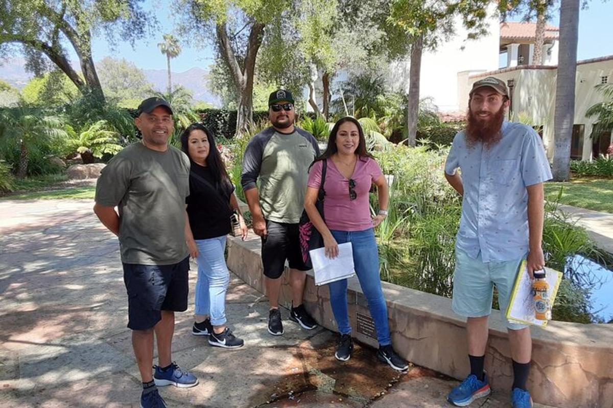 a group of people standing next to a wall