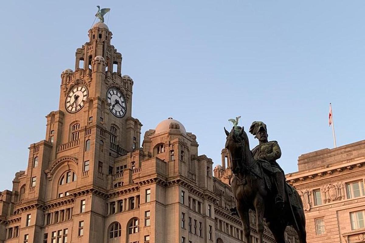 a large building with a clock tower and a statue