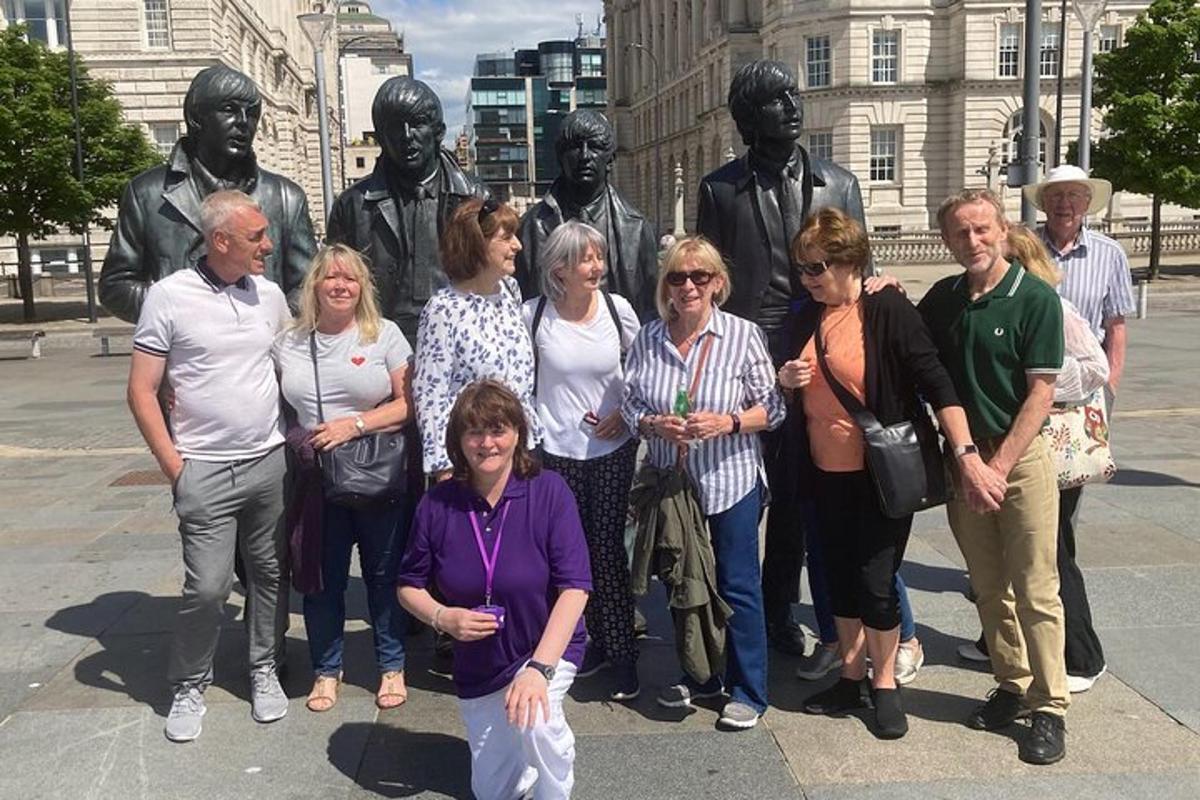 a group of people standing in front of a statue