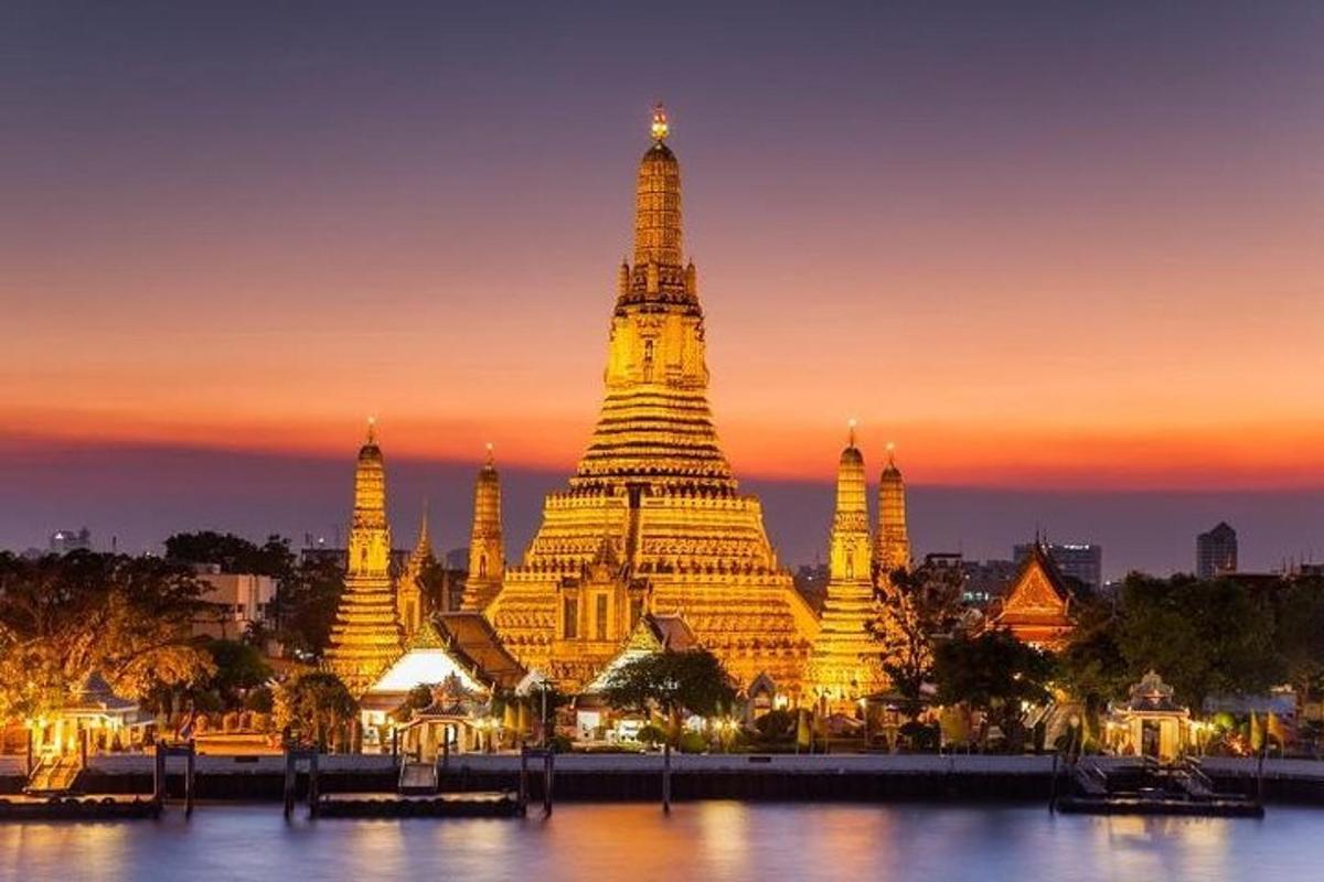 a large building with a tower at sunset