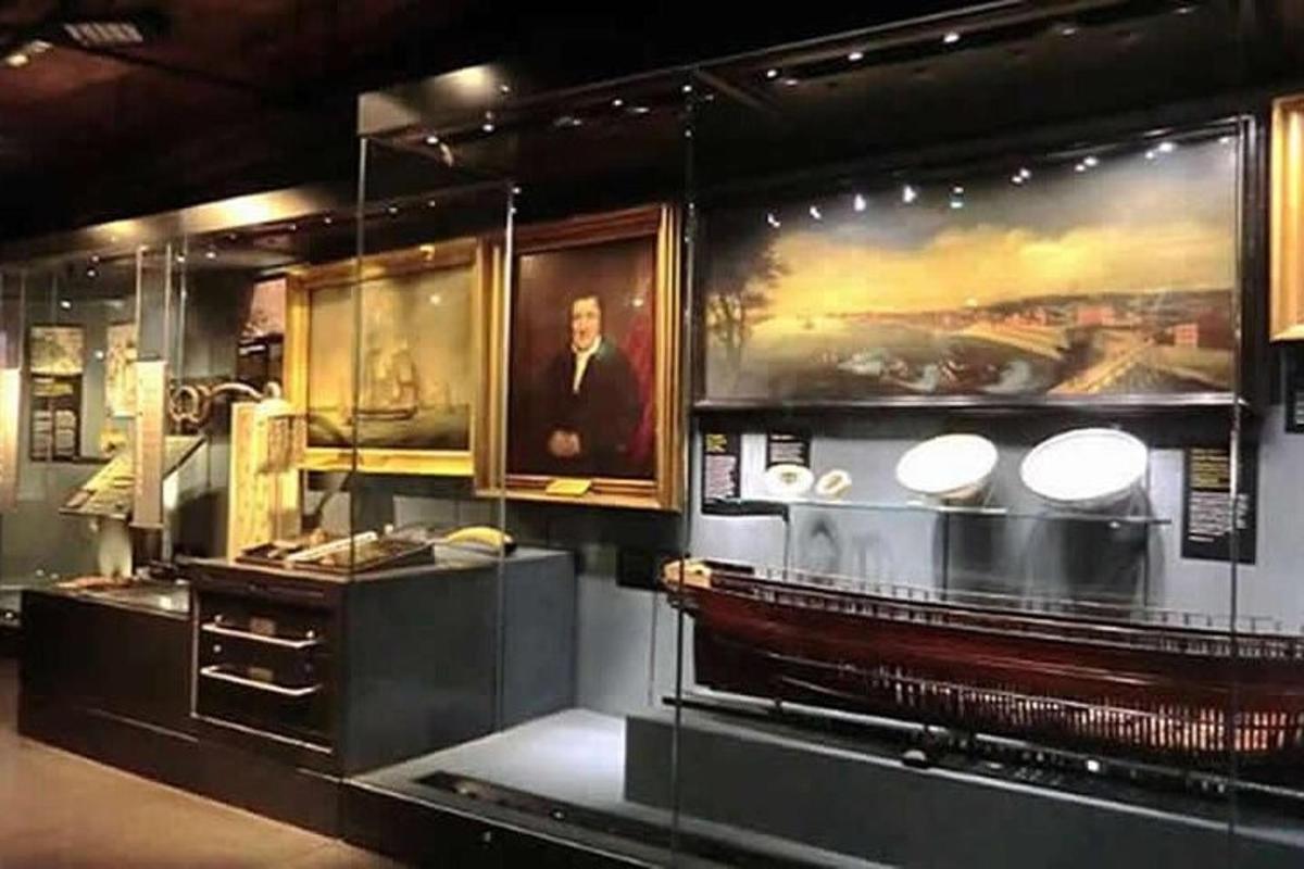 a museum exhibit with a portrait of a man on the wall