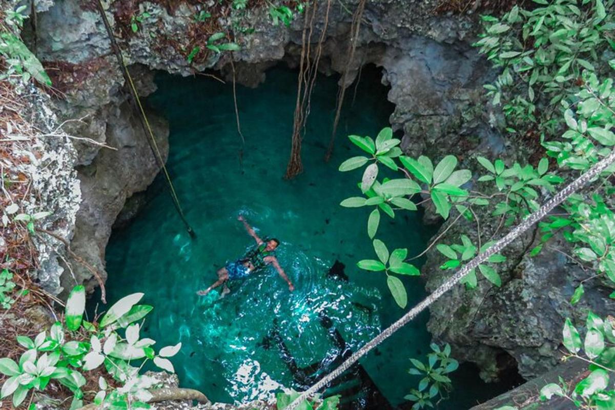 a person in a pool of water in a cave