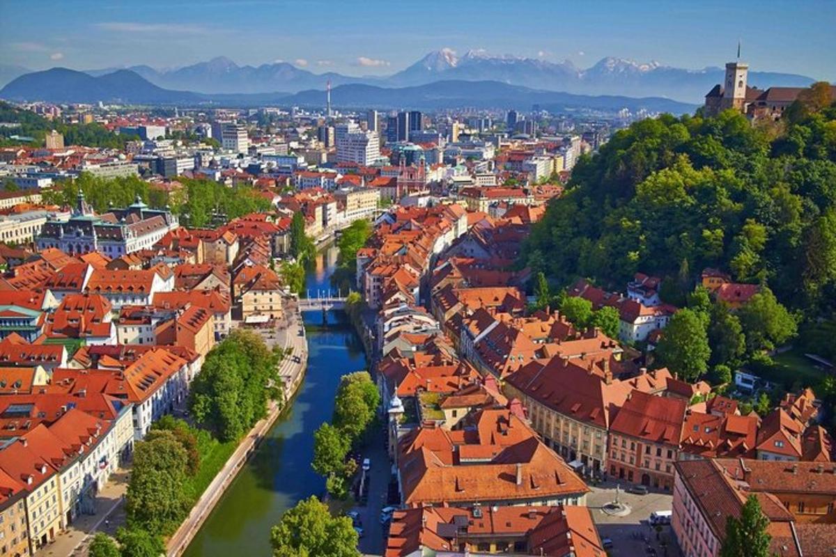 a view of a city with red roofs and a river