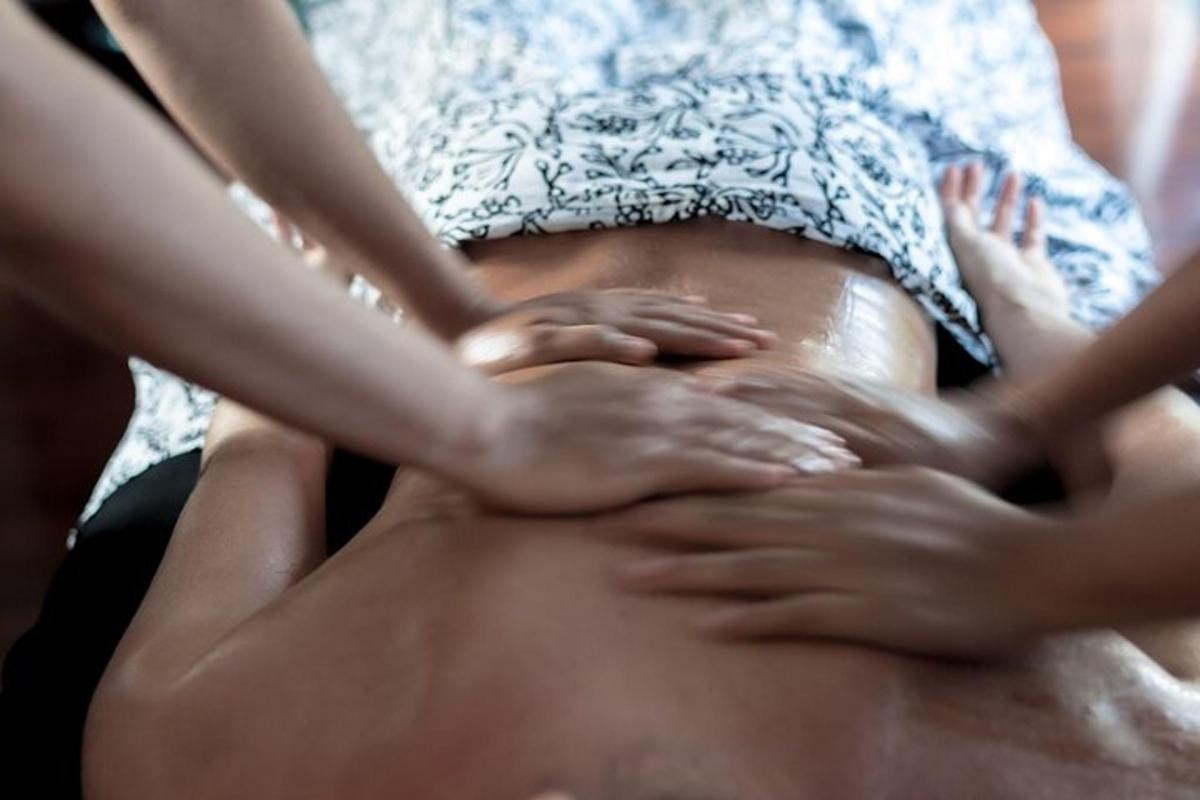 a man getting his hair brushed by a woman