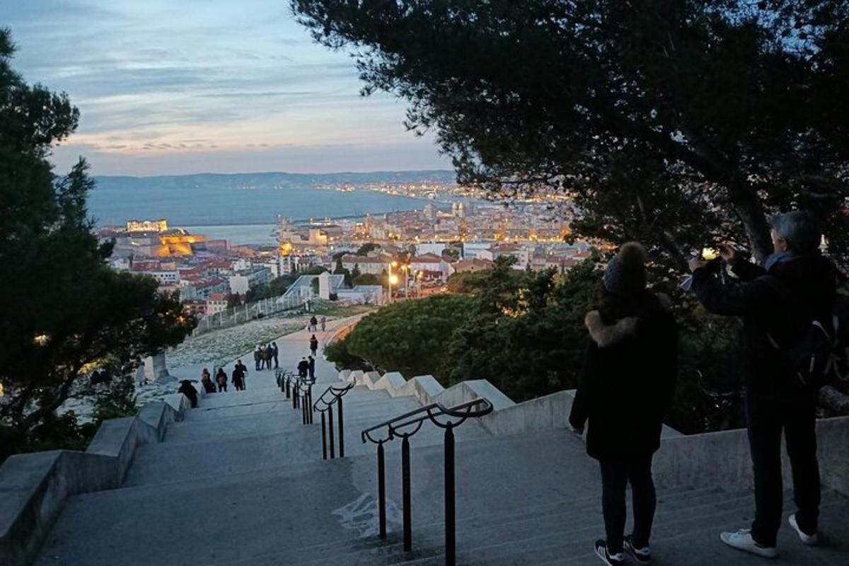 a couple taking a picture of a city at dusk