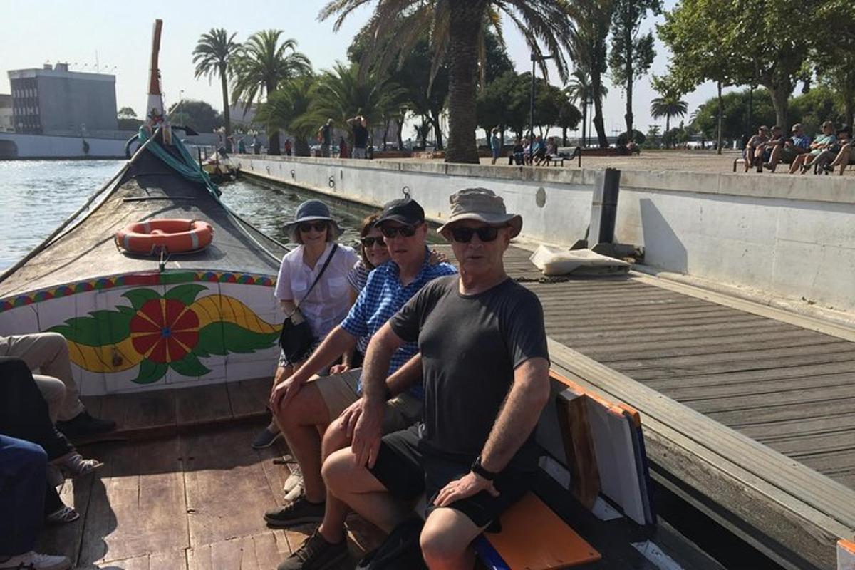 a group of people sitting on a boat on the water