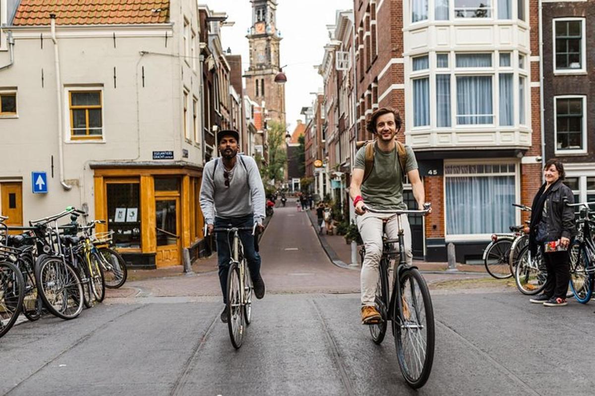 two men riding bikes down a city street