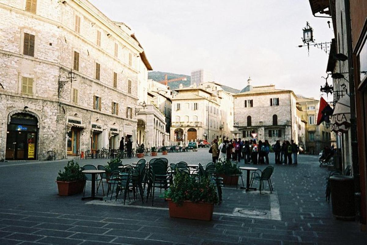 a city street with tables and chairs and buildings