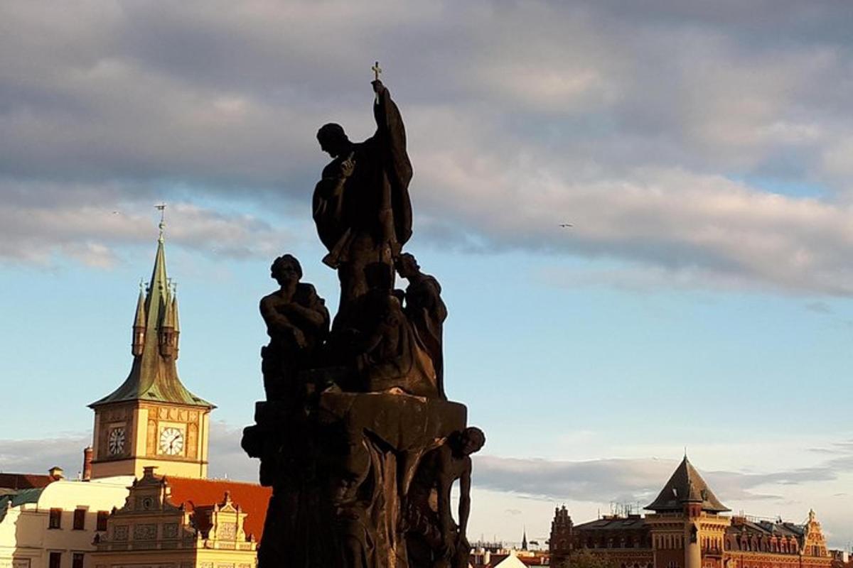 a statue in front of a building with a clock tower