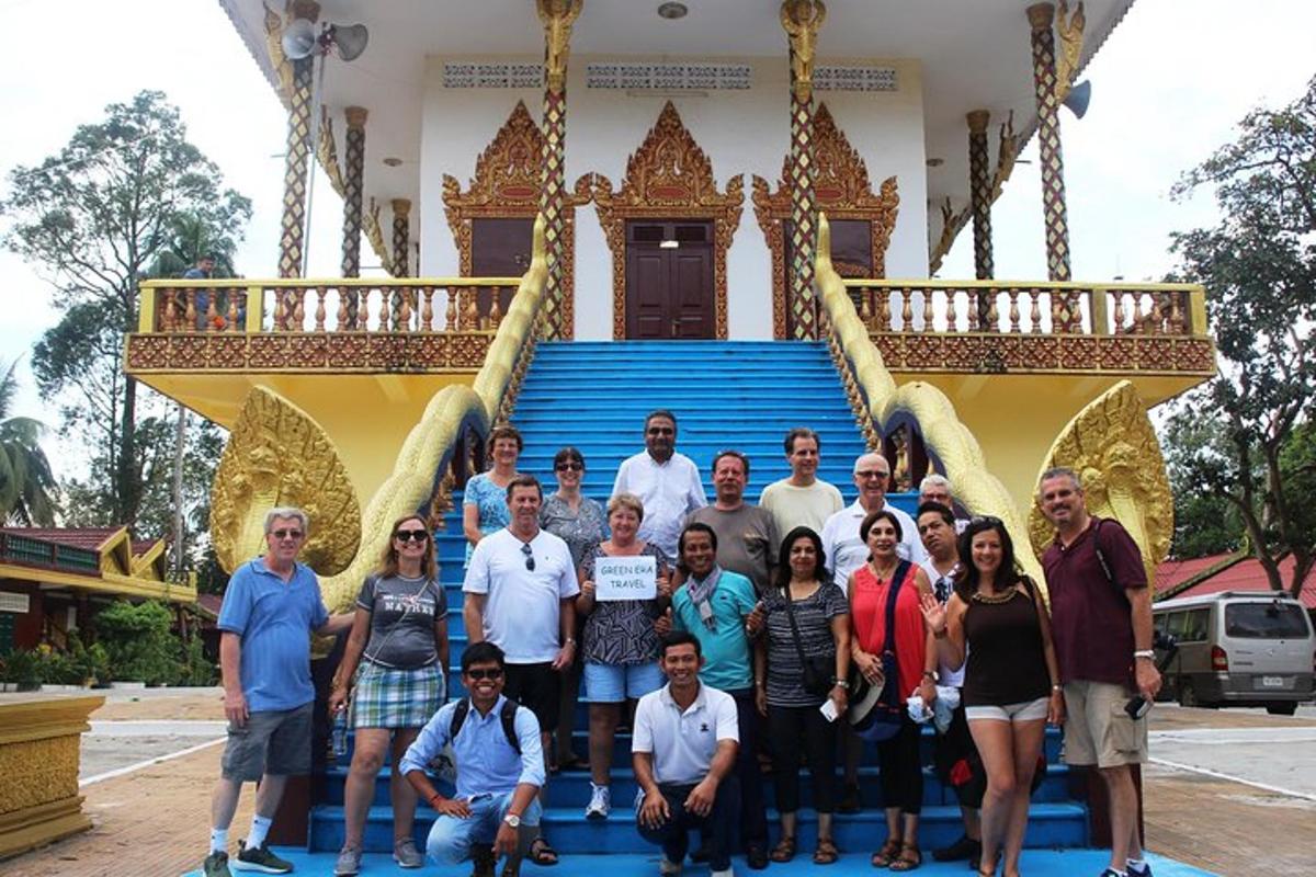a group of people posing for a picture in front of a building