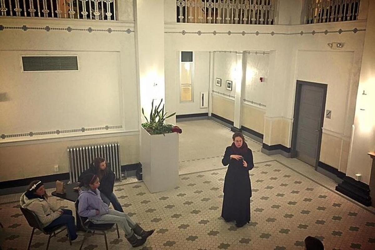 a woman standing in a room with a group of people