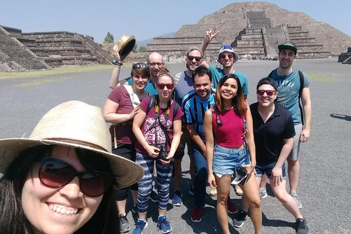 a group of people posing in front of the pyramid