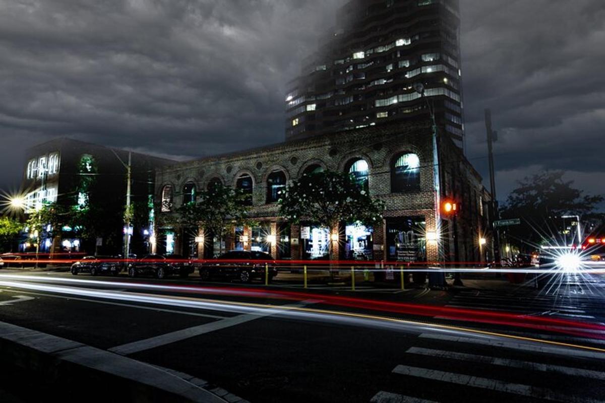 a city street with a large building at night