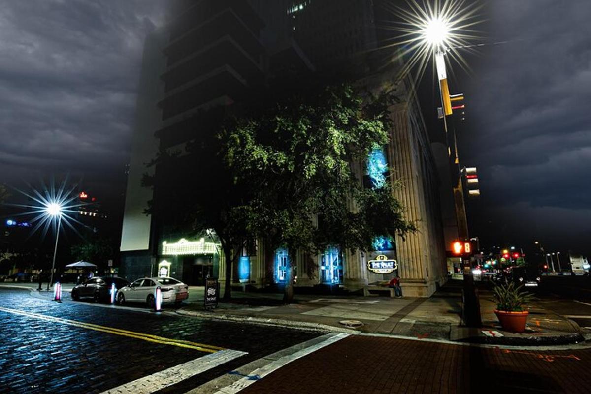 a city street at night with street lights and a building