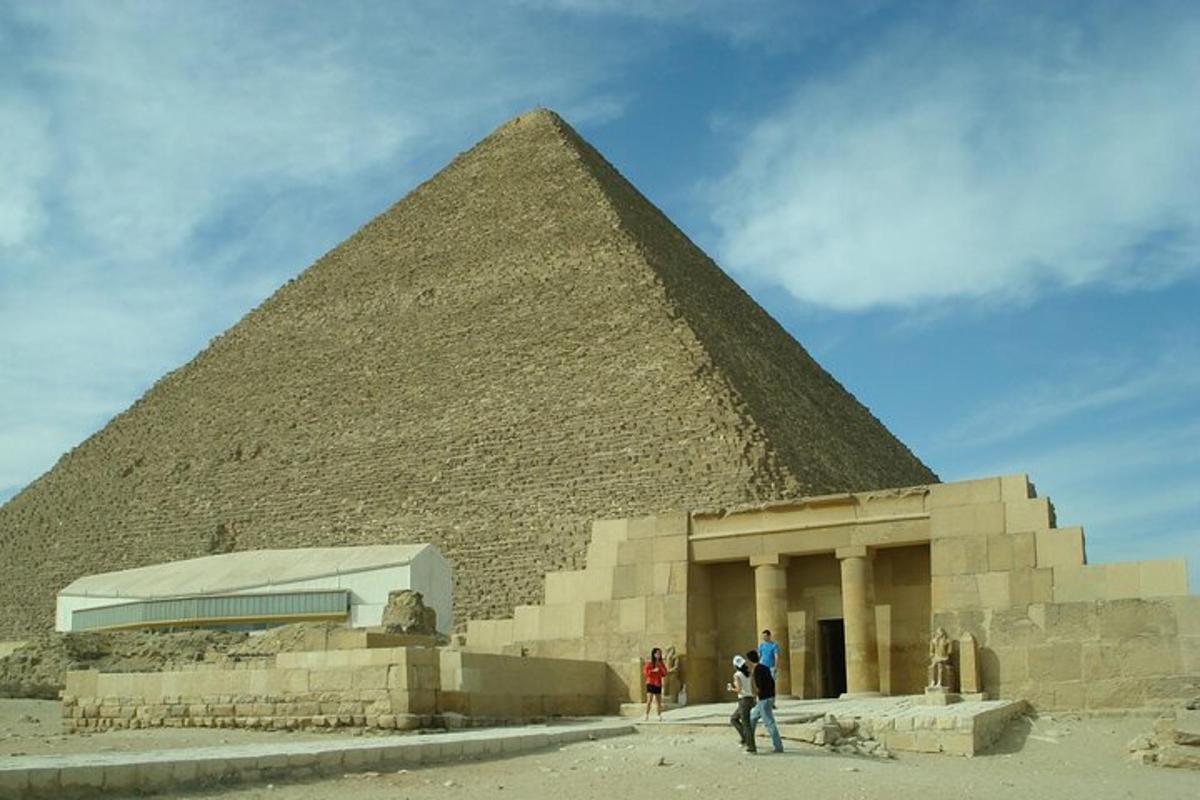 a pyramid with people standing in front of it
