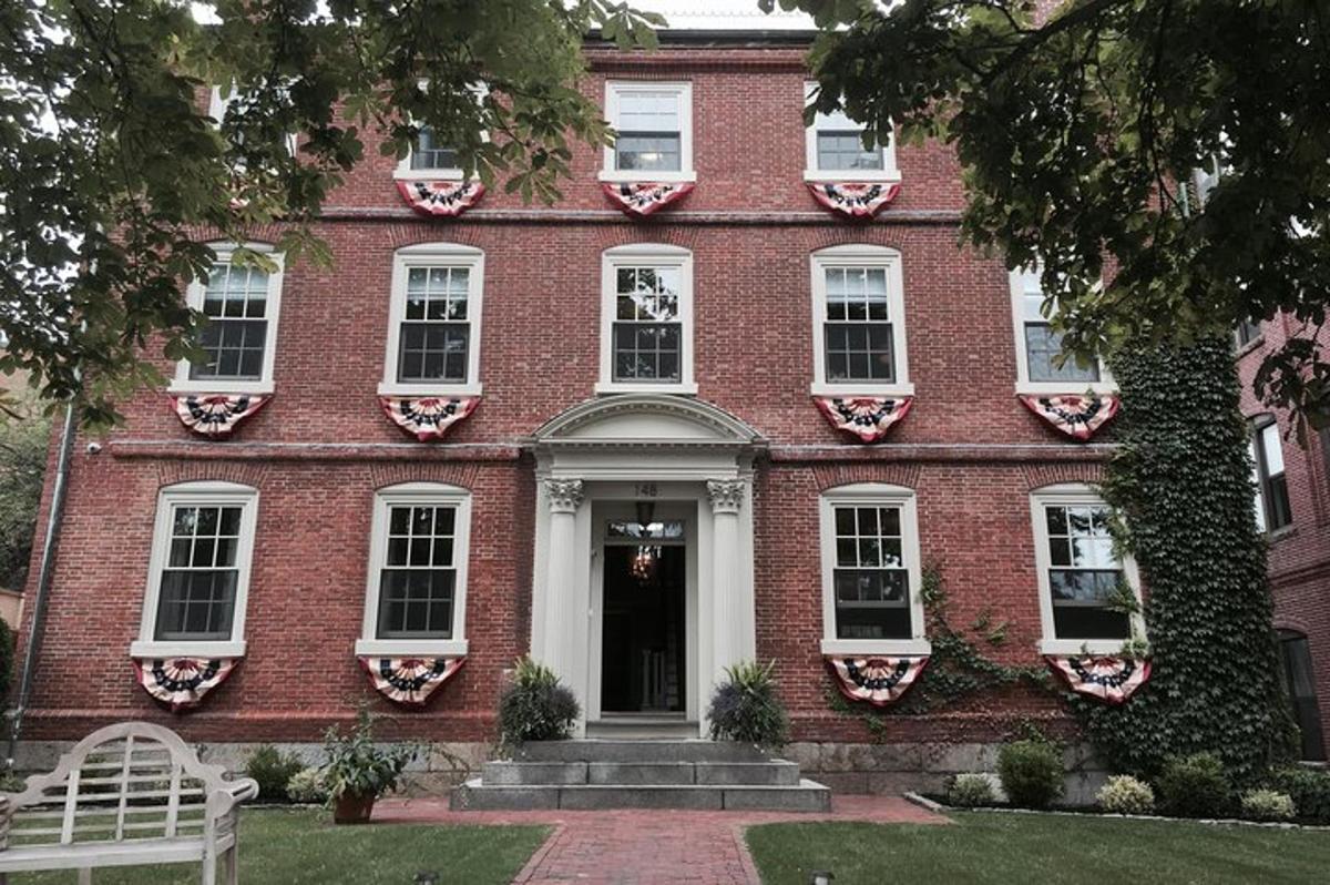a red brick house with a bench in front of it