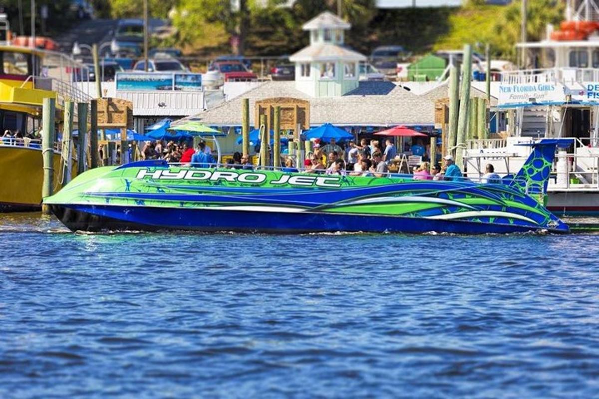 a blue and green boat in a body of water