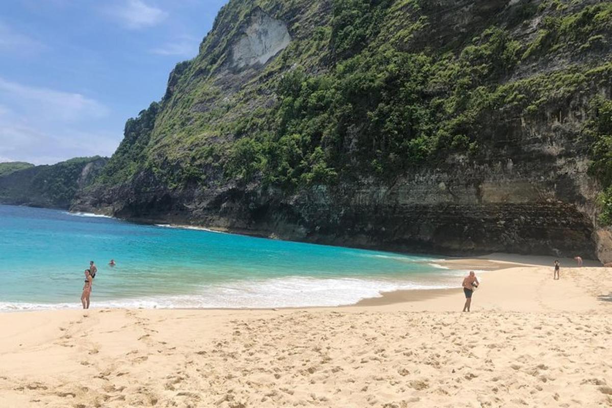 un gruppo di persone in piedi su una spiaggia vicino all'oceano