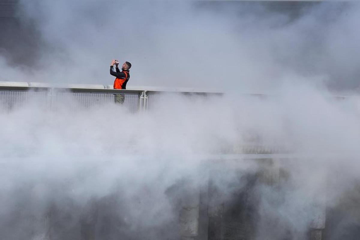 a man standing on top of a building in the fog